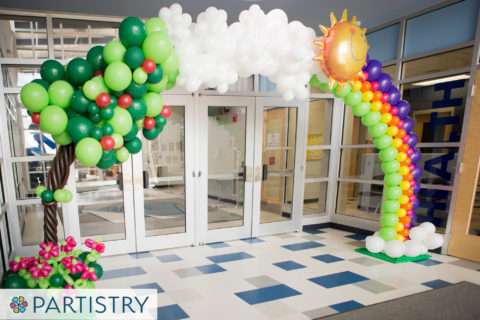 Balloon arch with rainbow and tree